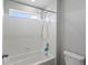 Full bath with a shower-tub combo, white tile, and natural lighting at 8346 E 132Nd Dr, Thornton, CO 80602