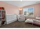 Bedroom with plush armchair, window with blind, and dresser with storage at 8346 E 132Nd Dr, Thornton, CO 80602