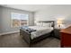 Bedroom with large window, gray bed frame, and neutral accents at 8346 E 132Nd Dr, Thornton, CO 80602