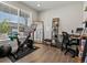 Bright home office featuring hardwood floors, a modern desk, and a large window for ample natural light at 8346 E 132Nd Dr, Thornton, CO 80602