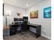 Home office with black desk, multiple monitors, and comfortable chair at 8346 E 132Nd Dr, Thornton, CO 80602