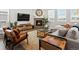 Cozy living room featuring modern furniture, a fireplace, and a large flat-screen television at 8346 E 132Nd Dr, Thornton, CO 80602