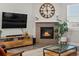 Cozy living room featuring modern furniture, a fireplace, and a large flat-screen television at 8346 E 132Nd Dr, Thornton, CO 80602