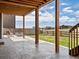 Covered patio with concrete flooring, wood beams, and scenic backyard views at 8346 E 132Nd Dr, Thornton, CO 80602
