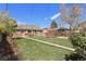 Large backyard with a shed, well-maintained lawn, and a brick home at 3300 Oneida St, Denver, CO 80207