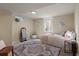 Finished basement bedroom with plush carpet, a cozy bed, and plenty of natural light at 3300 Oneida St, Denver, CO 80207