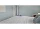 A serene bedroom with white bedding, soft blue walls, and ample closet space at 3300 Oneida St, Denver, CO 80207