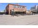 Station 26 Brewing exterior boasts a spacious outdoor patio with picnic tables under a bright blue sky at 3300 Oneida St, Denver, CO 80207