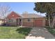 Charming single-story brick home with a well-maintained lawn and red accents at 3300 Oneida St, Denver, CO 80207