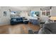 Cozy living room with hardwood floors, a comfortable blue sofa, and a flat-screen TV at 3300 Oneida St, Denver, CO 80207