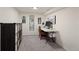 Well-lit office space with a modern desk, decor, and storage shelf for organization at 3300 Oneida St, Denver, CO 80207