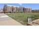 Scenic view of a grassy park with a building in the background, featuring a 