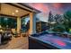 Relaxing outdoor space with a hot tub, covered patio, seating area, and a gazebo in the background at 7 Sandpiper Cir, Thornton, CO 80241