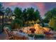 Backyard featuring a tranquil water feature, lush greenery, and cozy seating area for outdoor relaxation at 7 Sandpiper Cir, Thornton, CO 80241