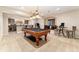 Finished basement area with a pool table, wet bar, and seating area near the window at 7 Sandpiper Cir, Thornton, CO 80241