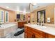 Bathroom featuring a soaking tub with tile surround, a tile shower, and double sink vanity at 7 Sandpiper Cir, Thornton, CO 80241