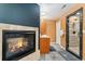Bathroom featuring a fireplace, wood cabinets, tile shower, and gray wood-look floors at 7 Sandpiper Cir, Thornton, CO 80241