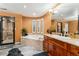 Bathroom featuring a soaking tub with tile surround, a tile shower, and double sink vanity at 7 Sandpiper Cir, Thornton, CO 80241