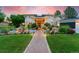 Beautiful home with a lush landscaped yard, a stone walkway, and a charming water feature at 7 Sandpiper Cir, Thornton, CO 80241