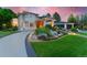 Landscaped front yard with stone accents and a circular driveway leading to the grand entrance of this home at 7 Sandpiper Cir, Thornton, CO 80241