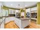 Bright kitchen with large island, stainless appliances, granite counters and white cabinetry at 7 Sandpiper Cir, Thornton, CO 80241