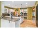 Spacious kitchen with a granite island, stainless appliances, white cabinets, and hardwood floors at 7 Sandpiper Cir, Thornton, CO 80241