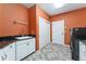 Laundry room features a sink, storage cabinets, washer and dryer, and light-colored floors at 7 Sandpiper Cir, Thornton, CO 80241