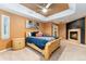 Beautiful bedroom featuring a fireplace, tray ceiling, and multiple windows at 7 Sandpiper Cir, Thornton, CO 80241