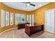 Home office with large desk and multiple windows with plantation shutters at 7 Sandpiper Cir, Thornton, CO 80241