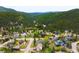 A scenic aerial view of homes nestled within a lush green mountain valley at 3257 Sun Ridge Ln, Evergreen, CO 80439