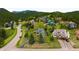 An aerial view of the property nestled among lush greenery with mountain views at 3257 Sun Ridge Ln, Evergreen, CO 80439