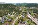 Aerial view displaying beautiful homes nestled into the lush green forest hills of the town at 3257 Sun Ridge Ln, Evergreen, CO 80439
