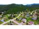 A stunning aerial showcases mountain homes nestled in a lush, green neighborhood at 3257 Sun Ridge Ln, Evergreen, CO 80439