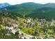 A panoramic view of homes nestled in a lush, green, mountainous neighborhood at 3257 Sun Ridge Ln, Evergreen, CO 80439