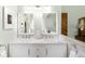 Bathroom vanity featuring marble counters, dual sinks, and wood door at 3257 Sun Ridge Ln, Evergreen, CO 80439