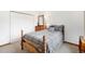 Cozy bedroom with classic wooden bed frame, closet, dresser, and soft patterned bedding at 3257 Sun Ridge Ln, Evergreen, CO 80439