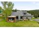 Beautiful home with a well-manicured lawn, mountain views and charming outdoor entertaining space at 3257 Sun Ridge Ln, Evergreen, CO 80439