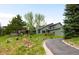 Exterior view of this charming home with mature trees and landscaping at 3257 Sun Ridge Ln, Evergreen, CO 80439