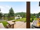 View from the porch, highlighting the greenery, landscaping and mountain views at 3257 Sun Ridge Ln, Evergreen, CO 80439