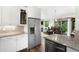 Open kitchen featuring granite counters, stainless refrigerator, adjacent dining area, and vaulted ceiling at 3257 Sun Ridge Ln, Evergreen, CO 80439