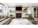 Living room with stone fireplace, ceiling fan, recessed lighting and floor-to-ceiling windows at 3257 Sun Ridge Ln, Evergreen, CO 80439