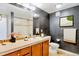 Stylish bathroom with dark gray walls, light fixtures, and a shower-tub combo at 7240 W Custer Ave # 417, Lakewood, CO 80226