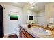 Bathroom featuring a double sink vanity with wood cabinets, tiled floors, and a shower-tub combo at 7240 W Custer Ave # 417, Lakewood, CO 80226