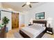 Well-lit bedroom with a ceiling fan, modern furniture, and a rustic barn-style door at 7240 W Custer Ave # 417, Lakewood, CO 80226