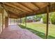 Covered back patio with seating area overlooking spacious, grassy backyard at 5419 E 113Th Ave, Thornton, CO 80233