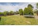 Vast backyard with lush lawn, complete with a trampoline and mature trees at 5419 E 113Th Ave, Thornton, CO 80233