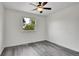 This light and bright bedroom features sleek gray floors, a modern ceiling fan, and a view at 5419 E 113Th Ave, Thornton, CO 80233