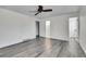 Bedroom with gray wood floors, ceiling fan, ensuite bathroom and a walk-in closet at 5419 E 113Th Ave, Thornton, CO 80233