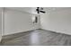 Bright bedroom featuring gray wood floors, a large window and ceiling fan at 5419 E 113Th Ave, Thornton, CO 80233