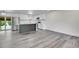 Spacious open kitchen with gray wood floors, stainless steel refrigerator and gray island at 5419 E 113Th Ave, Thornton, CO 80233